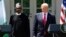 President Donald Trump and Nigerian President Muhammadu Buhari arrive for a news conference in the White House Rose Garden in Washington, April 30, 2018. 