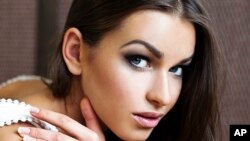 FILE - Anna Duritskaya poses for a photo for a modeling portfolio in Kyiv, Ukraine, Aug. 28, 2012.