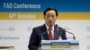 FILE - Qu Dongyu from China addresses a plenary meeting of the 41st Session of the Conference, at the FAO headquarters in Rome, June 22, 2019.