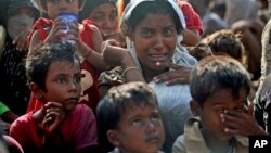 A rescued migrant weeps upon arrival Simpang Tiga, Aceh province, Indonesia, May 20, 2015. Many Rohingya and Bangladeshi migrants are trapped at sea in a growing crisis confronting Southeast Asia. (AP Photo/Binsar Bakkara)