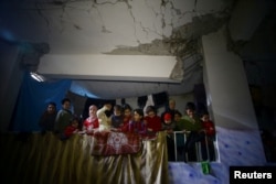 Children are seen in a shelter in the besieged town of Douma, eastern Ghouta, near Damascus, Syria, March 11, 2018.