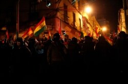A cordon of police block demonstrators from reaching the government palace during a protest against President Evo Morales' reelection, in La Paz, Bolivia, Nov. 8, 2019.