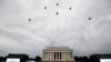The U.S. Army Band performs and the U.S. Navy Blue Angels fly over at the end of an Independence Day celebration in front of the Lincoln Memorial, July 4, 2019, in Washington.
