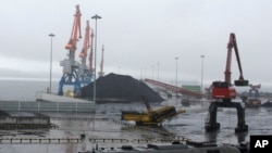 Coal brought from Siberia is ready to be loaded onto a ship bound for China in the North Korean special economic zone of Rason.