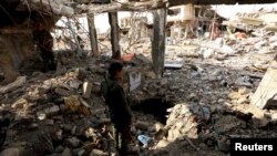 FILE - A member of the Peshmerga forces inspects a tunnel used by Islamic State militants in the town of Sinjar, Dec. 1, 2015.