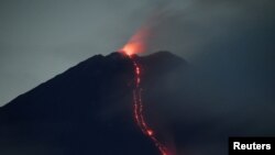 FILE - Mount Semeru volcano spews hot lava as it erupts, as seen from Oro-oro Ombo village in Lumajang, East Java province, Indonesia, January 17, 2021.