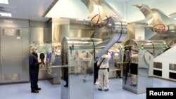 FILE - A employee at the South African pharmaceutical company Aspen Pharmacare works at a vaccine facility in Gqeberha, South Africa, Oct. 25, 2021.