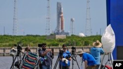 Photographers pack up their equipment as NASA's new moon rocket sits on Launch Pad 39-B after being scrubbed at the Kennedy Space Center, Sept. 3, 2022, in Cape Canaveral, Fla.