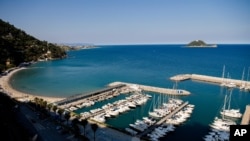 FILE - This May 21, 2020, photo shows the port in Alassio, Italy. Italy is expecting a surge of migrants.