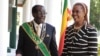 FILE: Zimbabwe President Robert Mugabe stands with his wife Grace, as they pose for a photo at State House in Harare, Oct, 28, 2014. 