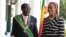 FILE: Zimbabwe President Robert Mugabe stands with his wife Grace, as they pose for a photo at State House in Harare, Oct, 28, 2014. 