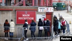 People queue for COVID-19 testing at a mass screening centre at Charlton Athletic Football Club as the spread of the coronavirus disease (COVID-19) continues in London, Britain, Jan. 3, 2021. 
