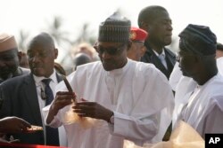 Nigeria's President, Muhammadu Buhari, center, prepare to cut the ribbon to Commission the Lekki deep seaport in Lagos, Jan. 23, 2023.