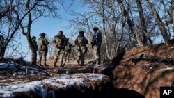 Ukrainian soldiers stand near trenches in the front line close to Bakhmut, Donetsk region, Ukraine, Feb. 8, 2023.