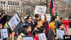 FILE - People demonstrate in front of the White House in Washington, Jan. 1, 2023, against the Afghan Taliban regime's ban on higher education for women.