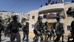 FILE- Israeli police march in the east Jerusalem neighborhood of Silwan, Feb. 10, 2023.