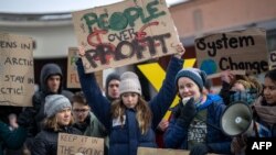 Sweden's Greta Thunberg, left, and other climate activists of the "Fridays for Future" movement demonstrate on the closing day of the World Economic Forum in Davos, Switzerland, Jan. 20, 2023. 