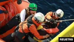 A migrant is rescued by members of Doctors Without Borders (MSF) during a search and rescue (SAR) operation in the Mediterranean Sea, Jan. 25, 2023. Mohamad Cheblak/Doctors without Borders/Handout via REUTERS