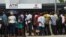 FILE - People queue to withdraw new naira notes from an Automated Teller Machine (ATM) on bank premises in Lagos, Feb. 1, 2023.