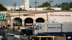 Investigators are seen outside Star Dance Studio in Monterey Park, Calif., Sunday, Jan. 22, 2023. (AP Photo/Jae C. Hong)