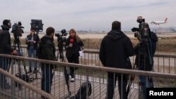FILE - Journalists gather after a commercial airplane made an emergency landing in Barcelona's El Prat airport, Spain, Dec. 7, 2022. Finnish, Norwegian, Danish and Icelandic unions will quit a global media federation, Jan. 31, 2023, in protest at "corruptive activity."