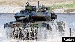 FILE - A Leopard 2 tank is seen during a visit of then German Chancellor Angela Merkel to NATO's new spearhead force "VJTF 2019" in Munster, May 20, 2019.