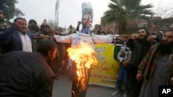 FILE - Pakistan Markazi Muslim League members in Peshawar burn an effigy of Danish anti-Islam activist Rasmus Paludan on Jan. 24, 2023, protesting his earlier burning of the Quran, a Muslim holy book. Turkey on Jan. 27 accused Denmark of endorsing a "hate crime."