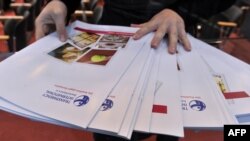 FILE - A worker lays out copies of corruption watchdog Transparency International's annual Corruption Perceptions Index prior to a press conference upon the release of the document, in Berlin, Oct. 26, 2010. 