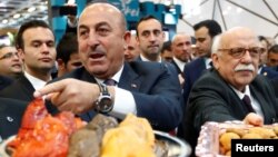 Turkey's Minister for Culture and Tourism Nabi Avci and Turkish Foreign Minister Mevlut Cavusoglu attend the International Tourism Trade Fair in Berlin, Germany, March 8, 2017. 