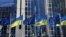 FILE - The flags of the European Union and Ukraine flutter outside the European Parliament building, in Brussels, Belgium, Feb. 28, 2022. 