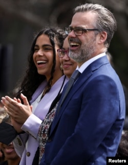 Leila Jackson, daughter of Judge Ketanji Brown Jackson, applauds with her father Patrick Jackson as her mother is celebrated at the White House as the first Black woman to serve on the U.S. Supreme Court, April 8, 2022.
