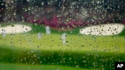 Rain falls on a plexiglass divider in the grandstand at Augusta National golf course on April 6, 2022, in Augusta, Ga. (AP Photo/Charlie Riedel)