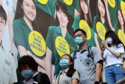 People wear protective face masks while heading in a metro station following the outbreak of COVID-19, in Taipei, Taiwan, May 12, 2021.