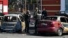 Ukrainian servicemen stand next to damaged cars after Russian shelling at the railway station in Kramatorsk, Ukraine, April 8, 2022.