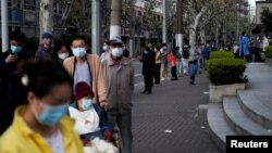 Residents line up for COVID-19 tests during a lockdown to curb the spread of the coronavirus, in Shanghai, China, April 9, 2022.