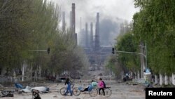 Smoke rises above a plant of Azovstal Iron and Steel Works in Mariupol