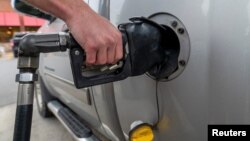A customer gets gasoline at a gas station in Plains, Pennsylvania, U.S. Oct. 19, 2022.