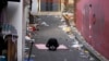 A man bows in the middle of the scene of a deadly accident following Saturday night's Halloween festivities in Seoul, South Korea, Monday, Oct. 31, 2022.