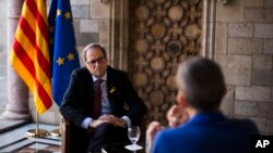 A Palestinian man rides his donkey cart past a building that was destroyed during the 11-day war in May of this year between Israel and the Palestinian Hamas movement, in Gaza City.