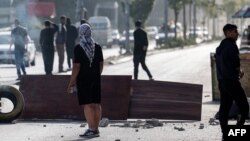 Palestinians confront Israeli troops at the entrance of the Nur Shams refugee camp near the northern West Bank town of Tulkarem, April 10, 2022.