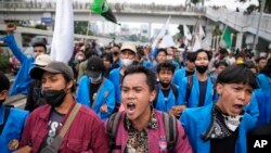 Students shout slogans during a rally outside the parliament in Jakarta, Indonesia, Monday, April 11, 2022. 