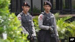 Armed police stand outside the Starbucks cafe where an attack occurred on Thursday, in Jakarta, Indonesia, Jan. 15, 2016. 