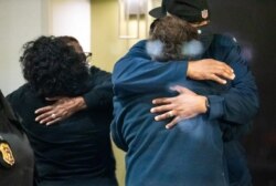 People embrace after learning that their loved one was safe after a mass casualty shooting at the FedEx facility in Indianapolis, Indiana, April 16, 2021.