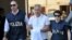 Italian police officers escort Francesco Inzerillo (C) after he was arrested in Palermo during an police/FBI operation called 'New Connection' on July 17, 2019. 
