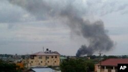 FILE - In this photo taken Sunday, July 10, 2016, black smoke is seen rising above the capital Juba, in South Sudan. 