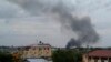 In this photo taken Sunday, July 10, 2016, black smoke is seen rising above the capital Juba, in South Sudan. 