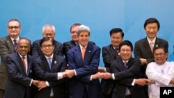 U.S. Secretary of State John Kerry, foreground third left, poses for a group picture with foreign ministers before commencing the 4th East Asia Summit (EAS) Foreign Ministers' Meeting in Naypyitaw, Myanmar, Sunday, Aug. 10, 2014.