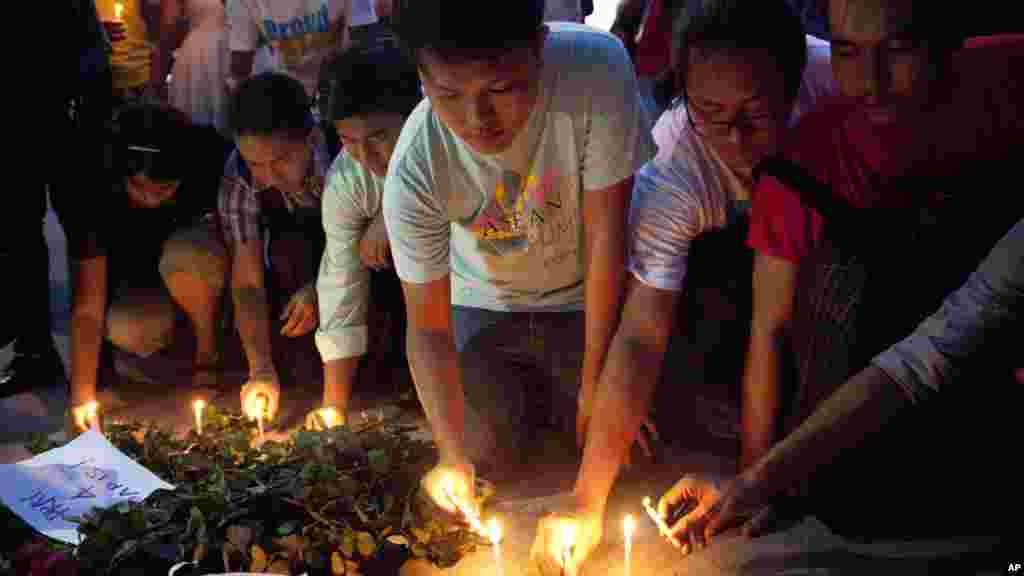 Students use candles to form a large ribbon during an event to mark World AIDS Day at a primary school in Hohhot, Inner Mongolia autonomous region, China.