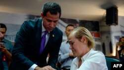 Venezuelan opposition leader and self-proclaimed acting president Juan Guaido (L) comforts oncological patient Mildred Valera during a special consultation commission meeting at the National Assembly building in Caracas on August 27, 2019. / AFP /…