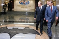 FILE - Russian President Vladimir Putin, left, visits the new GRU military intelligence headquarters building in Moscow, Nov. 8, 2006.